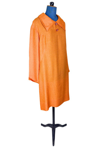 Vintage 1960s orange textured mod dress with long sleeves, large pointed collar, and two decorative rhinestone buttons. The long sleeves have turned cuffs. The A-line dress has bust darts through the sides and diagonally down towards the hips. Closes in the back with a cotton twill zipper.