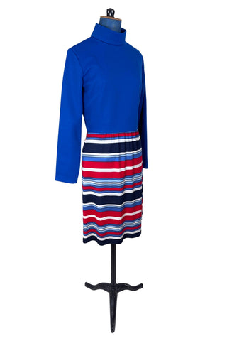 Vintage 1960s day dress with turtleneck rolled collar, long sleeves, and contrasting striped skirt in red, white and blue. Closes in the back with a cotton twill zipper. 

Designed by JC Penney Fashions.