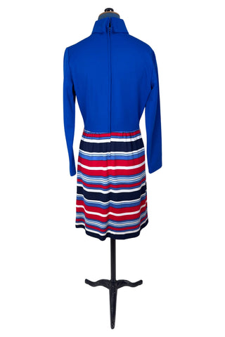 Vintage 1960s day dress with turtleneck rolled collar, long sleeves, and contrasting striped skirt in red, white and blue. Closes in the back with a cotton twill zipper. 

Designed by JC Penney Fashions.