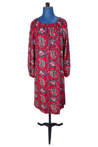 Vintage 1970s bohemian dress with paisley print on a rich red background. The dress is made from cotton, and  features a round, elasticized neckline and long sleeves with elasticized cuffs. There are no closures, it is a pullover style.