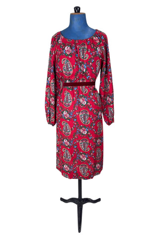 Vintage 1970s bohemian dress with paisley print on a rich red background. The dress is made from cotton, and  features a round, elasticized neckline and long sleeves with elasticized cuffs. There are no closures, it is a pullover style.