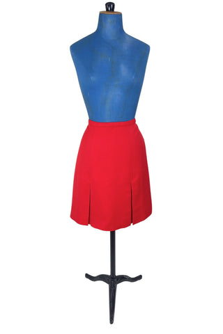Vintage 1960s skirt in structured red wool gabardine with two front box pleats. The skirt closes in the back with a cotton twill zipper, and is fully lined in red acetate. 