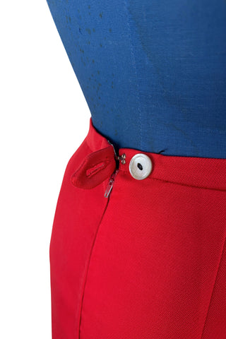 Vintage 1960s skirt in structured red wool gabardine with two front box pleats. The skirt closes in the back with a cotton twill zipper, and is fully lined in red acetate. 