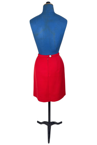Vintage 1960s skirt in structured red wool gabardine with two front box pleats. The skirt closes in the back with a cotton twill zipper, and is fully lined in red acetate. 