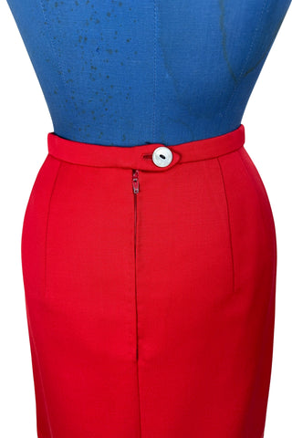 Vintage 1960s skirt in structured red wool gabardine with two front box pleats. The skirt closes in the back with a cotton twill zipper, and is fully lined in red acetate. 