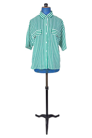 Vintage 1980s button down shirt with white and green stripes. Features short sleeves and wide faux-pocket flaps with button closures. Can be worn fully buttoned or with an open neckline for two distinct looks.

Designed by Carl B (Carl Backman Ent.). Made in Canada. 