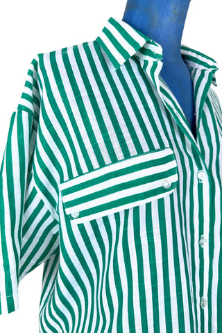 Vintage 1980s button down shirt with white and green stripes. Features short sleeves and wide faux-pocket flaps with button closures. Can be worn fully buttoned or with an open neckline for two distinct looks.

Designed by Carl B (Carl Backman Ent.). Made in Canada. 