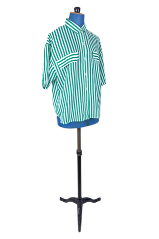 Vintage 1980s button down shirt with white and green stripes. Features short sleeves and wide faux-pocket flaps with button closures. Can be worn fully buttoned or with an open neckline for two distinct looks.

Designed by Carl B (Carl Backman Ent.). Made in Canada. 