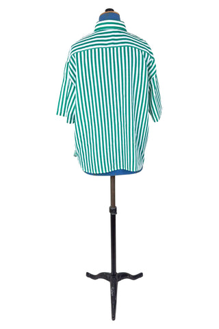 Vintage 1980s button down shirt with white and green stripes. Features short sleeves and wide faux-pocket flaps with button closures. Can be worn fully buttoned or with an open neckline for two distinct looks.

Designed by Carl B (Carl Backman Ent.). Made in Canada. 