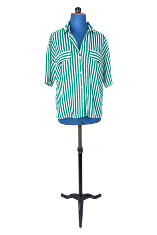 Vintage 1980s button down shirt with white and green stripes. Features short sleeves and wide faux-pocket flaps with button closures. Can be worn fully buttoned or with an open neckline for two distinct looks.

Designed by Carl B (Carl Backman Ent.). Made in Canada. 