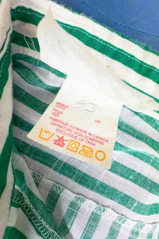Vintage 1980s button down shirt with white and green stripes. Features short sleeves and wide faux-pocket flaps with button closures. Can be worn fully buttoned or with an open neckline for two distinct looks.

Designed by Carl B (Carl Backman Ent.). Made in Canada. 