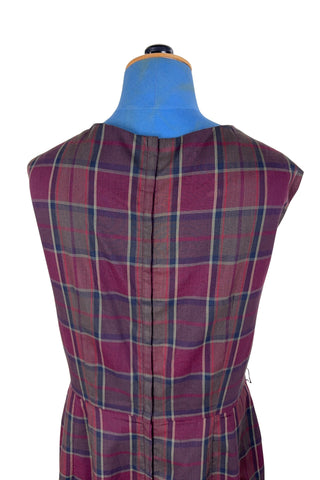 Vintage 1950s sleeveless day dress in dark red plaid cotton. The dress closes in the back with a metal zipper, and is unlined.

Designed by Henry-Lee. 