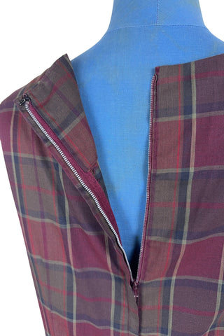 Vintage 1950s sleeveless day dress in dark red plaid cotton. The dress closes in the back with a metal zipper, and is unlined.

Designed by Henry-Lee. 