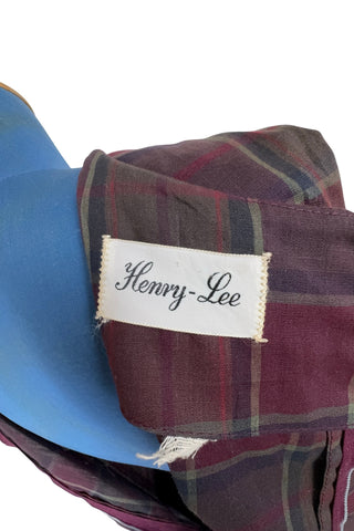 Vintage 1950s sleeveless day dress in dark red plaid cotton. The dress closes in the back with a metal zipper, and is unlined.

Designed by Henry-Lee. 