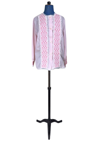 Vintage late 1950s pajama top shirt in light pink cotton with wide panels of eyelet embroidery down the front and at the sleeve cuffs. The high collar, sleeves, and hem are finished with tiny white ruffled lace.

Designed by Perri-Ann Lingerie in Montreal, Canada.