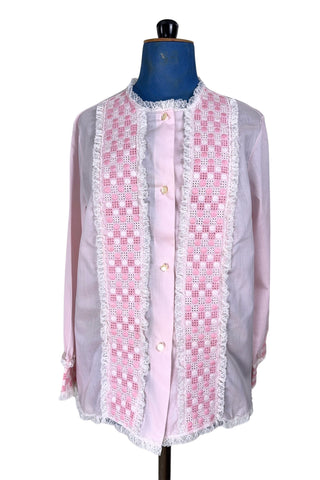 Vintage late 1950s pajama top shirt in light pink cotton with wide panels of eyelet embroidery down the front and at the sleeve cuffs. The high collar, sleeves, and hem are finished with tiny white ruffled lace.

Designed by Perri-Ann Lingerie in Montreal, Canada.