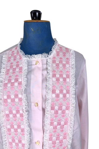 Vintage late 1950s pajama top shirt in light pink cotton with wide panels of eyelet embroidery down the front and at the sleeve cuffs. The high collar, sleeves, and hem are finished with tiny white ruffled lace.

Designed by Perri-Ann Lingerie in Montreal, Canada.