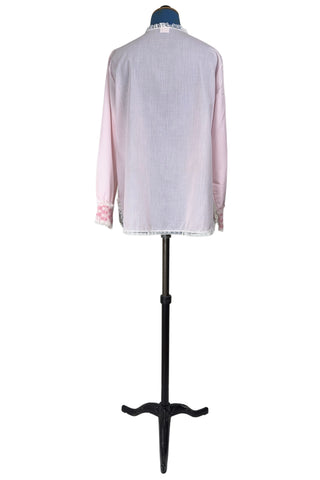 Vintage late 1950s pajama top shirt in light pink cotton with wide panels of eyelet embroidery down the front and at the sleeve cuffs. The high collar, sleeves, and hem are finished with tiny white ruffled lace.

Designed by Perri-Ann Lingerie in Montreal, Canada.