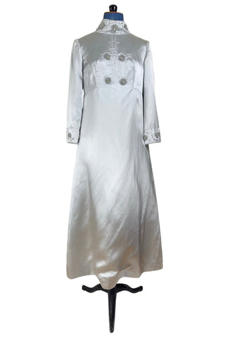 Vintage 1960s evening gown in silver grey heavy silk satin with large beaded medallion clusters and delicate silver beaded ‘vines’. The gown features a high neckline, empire waist (notice the unique inset bust darts), long sleeves with wide cuffs, and a gently flared A-line full length skirt.

Closes in the back with a cotton twill nylon coil Lightning zipper. Fully lined with soft cornflower blue silk.