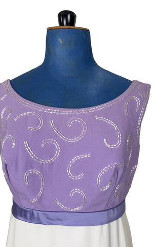 Gorgeous vintage 1960s evening gown with lilac purple bodice and creamy white long A-line skirt. The empire waist gown’s bodice features swirls of pearly white beading, and is finished with a wide purple satin sash at the waist with a large bow in the back.

The sleeveless dress has a wide round collar with a lower scoop back. It is fully lined, and closes in the back with a cotton twill nylon zipper.