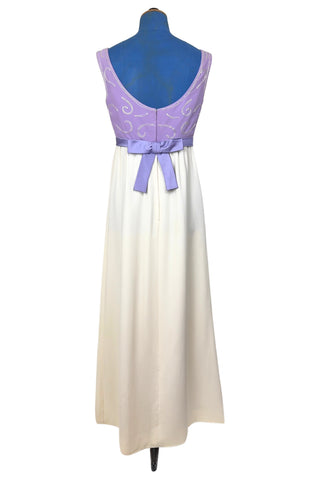 Gorgeous vintage 1960s evening gown with lilac purple bodice and creamy white long A-line skirt. The empire waist gown’s bodice features swirls of pearly white beading, and is finished with a wide purple satin sash at the waist with a large bow in the back.

The sleeveless dress has a wide round collar with a lower scoop back. It is fully lined, and closes in the back with a cotton twill nylon zipper.