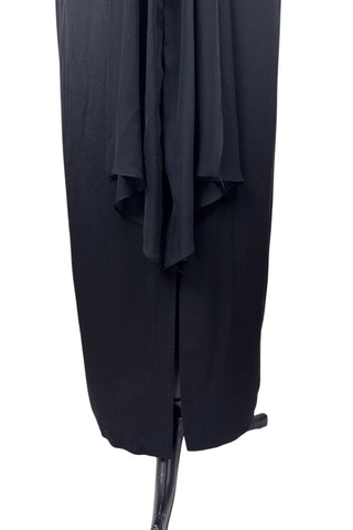 Vintage 1990s black evening gown with silver tone rhinestone brooch at the neck. This sophisticated dress has a column silhouette, and features a sweetheart neckline, spaghetti straps, and a slit at the back of the skirt. Sheer black chiffon is layered and draped at the neck in a halter style, and flows down the bodice to the back of the waist where it forms a floating overlay ruffle.

The dress is fully lined with black acetate, and closes in the back with a nylon zipper.

Marked Size 10. Made in U.S.A.
