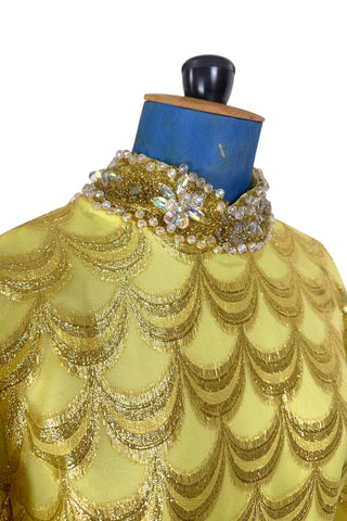 Absolutely stunning true vintage 1960s evening gown in gold metallic figured sheer chiffon, with intricate heavy beading at the high neckline and waist, with large beaded medallion clusters at the tops of the side slits in the skirt. The dress is lined through the bodice and skirt, while the sleeves are left unlined to highlight the sheer gold fabric. 

Designed and made by Fontana’s New York. 

The dress closes in the back with a cotton twill nylon zipper.