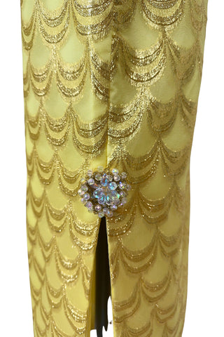 Absolutely stunning true vintage 1960s evening gown in gold metallic figured sheer chiffon, with intricate heavy beading at the high neckline and waist, with large beaded medallion clusters at the tops of the side slits in the skirt. The dress is lined through the bodice and skirt, while the sleeves are left unlined to highlight the sheer gold fabric. 

Designed and made by Fontana’s New York. 

The dress closes in the back with a cotton twill nylon zipper.