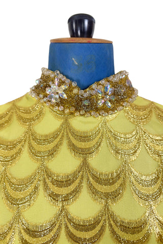 Absolutely stunning true vintage 1960s evening gown in gold metallic figured sheer chiffon, with intricate heavy beading at the high neckline and waist, with large beaded medallion clusters at the tops of the side slits in the skirt. The dress is lined through the bodice and skirt, while the sleeves are left unlined to highlight the sheer gold fabric. 

Designed and made by Fontana’s New York. 

The dress closes in the back with a cotton twill nylon zipper.