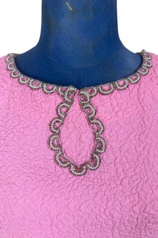 Stunning true vintage 1960s evening gown in candy pink textured crepe with scalloped silver beading at the neckline and trimming the short sleeve cuffs.

The gown is designed with a close-fitting column silhouette, while the textured crepe molds beautifully to your curves.

The gown is fully lined and closes in the back with a cotton twill nylon zipper.