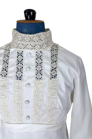 Vintage late 1960s or early 1970s wedding dress with high neck, long sleeves, and an empire waist. This Edwardian revival style dress features crochet lace panels at the neck, down the front and back of the bodice, and trimming the long sleeve cuffs. The dress has a large flat bow at the back of the waist.

Channel your inner Priscilla Presley in this lovely vintage gown.

The dress closes in the back with a cotton twill nylon zipper.