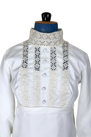 Vintage late 1960s or early 1970s wedding dress with high neck, long sleeves, and an empire waist. This Edwardian revival style dress features crochet lace panels at the neck, down the front and back of the bodice, and trimming the long sleeve cuffs. The dress has a large flat bow at the back of the waist.

Channel your inner Priscilla Presley in this lovely vintage gown.

The dress closes in the back with a cotton twill nylon zipper.