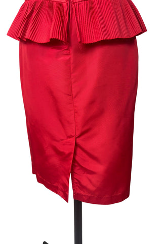Vintage late 1980s or early 1990s cocktail dress in bold red acetate faille fabric with subtle ribbed texture. The strapless bodice has a wrapped appearance, trimmed with wide panels of accordion pleated ruffles. A large bow at the waist is crowned with a wide band of rhinestones.

Designed with an hourglass silhouette, the dress hugs and accentuates curves for a bombshell fit. 

Marked size 9/10 (vintage sizing - see measurements section at right).

Designed by Collections JS. Made in Canada.