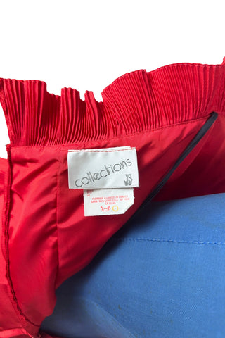 Vintage late 1980s or early 1990s cocktail dress in bold red acetate faille fabric with subtle ribbed texture. The strapless bodice has a wrapped appearance, trimmed with wide panels of accordion pleated ruffles. A large bow at the waist is crowned with a wide band of rhinestones.

Designed with an hourglass silhouette, the dress hugs and accentuates curves for a bombshell fit. 

Marked size 9/10 (vintage sizing - see measurements section at right).

Designed by Collections JS. Made in Canada.